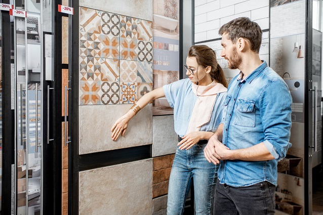 man and woman choosing tiles from the store